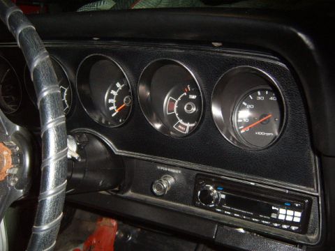 1973 Ford Ranchero - The interior dashboard of a 1973 Ford Ranchero features a tachometer, temperature gauge, and fuel gauge, along with a wiper washer switch a…