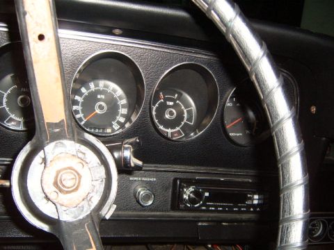 1973 Ford Ranchero - The interior of a 1973 Ford Ranchero shows a dashboard with gauges, a steering wheel, and an aftermarket radio.