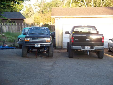 1977 Ford F-150 - Rear view of a lifted black Ford F-150 with aftermarket wheels and a license plate reading BF15632.