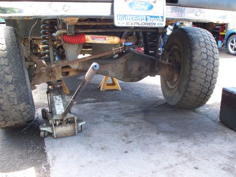 1977 Ford F-150 - The rear suspension and axle of a 1977 Ford F-150 are visible, supported by a jack and stands.