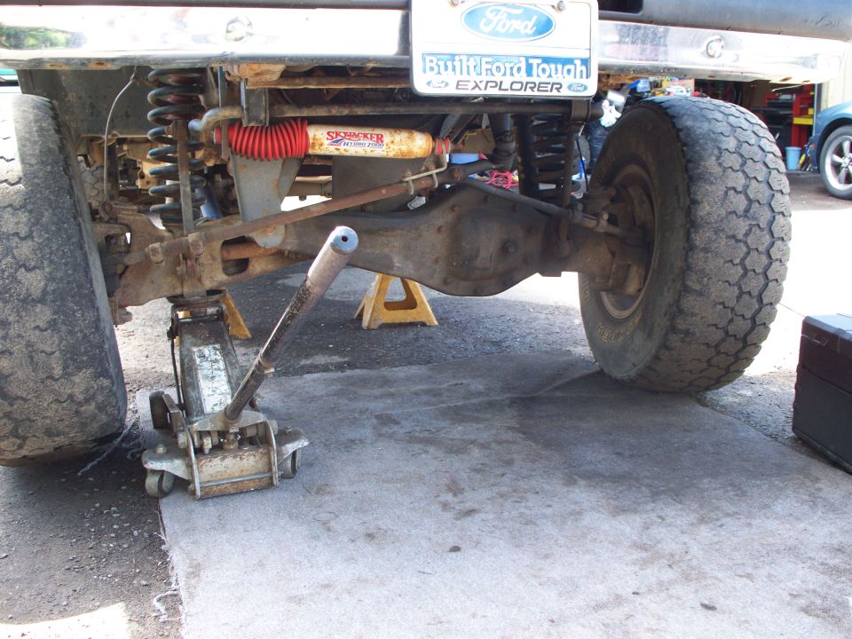 1977 Ford F-150 rear axle assembly supported by a floor jack and jack stands