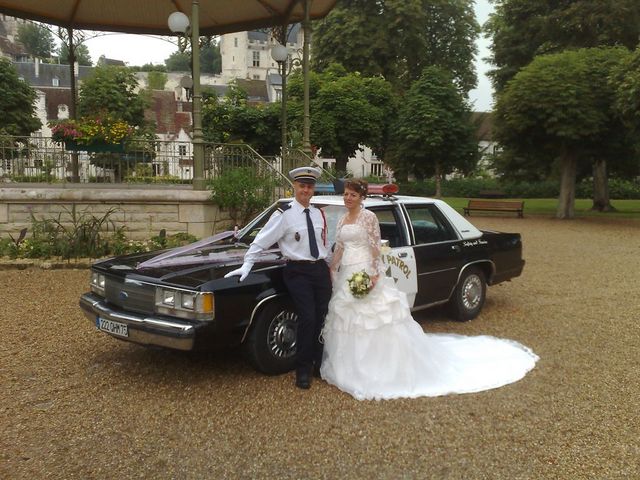 Black and white police car with wedding couple, front quarter view. "PATROL" text visible on door
