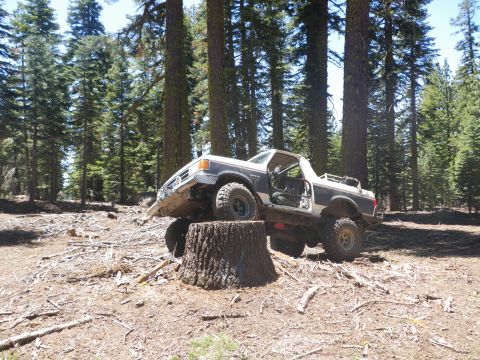 1991 Ford Bronco - This 1991 Ford Bronco navigates an obstacle during an off-road excursion in a wooded area.