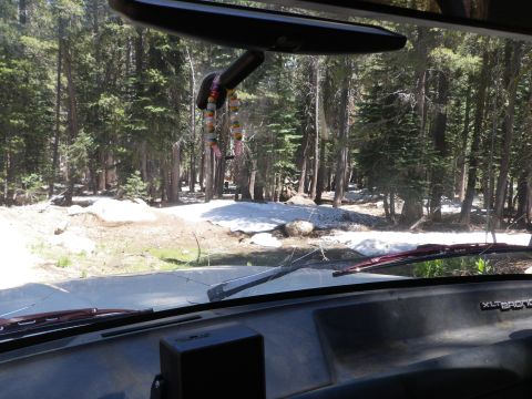 1991 Ford Bronco - Driving through a forest road with snow patches in a 1991 Ford Bronco.