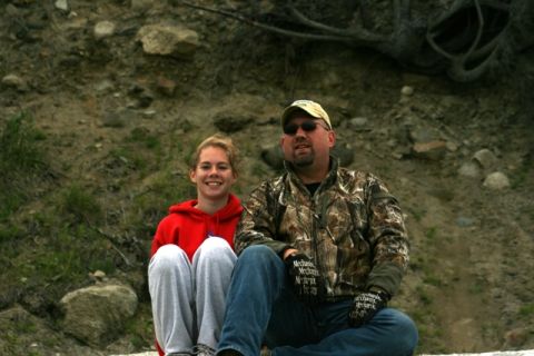 1990 Chevrolet Suburban - A father and daughter pose for a photo while sitting outdoors near a rocky embankment.