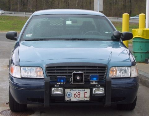 1998 Ford Crown Victoria - Massachusetts State Police 1998 Ford Crown Victoria, front view, equipped with a push bumper and emergency lights.