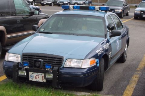 1998 Ford Crown Victoria - Massachusetts State Police Crown Victoria parked next to another vehicle. It has a push bumper and light bar.