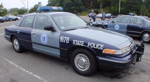 1998 Ford Crown Victoria - Two Massachusetts State Police cruisers, a Ford Crown Victoria and another sedan, parked side-by-side.