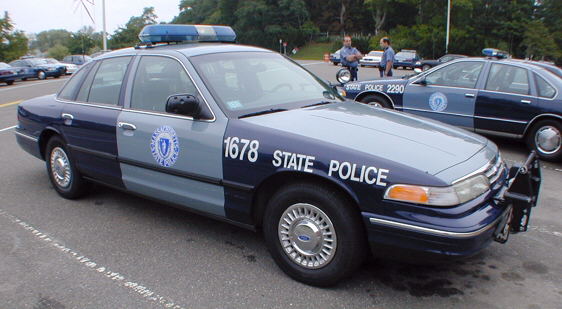 1998 Ford Crown Victoria police car, dark blue and grey, marked 1678 STATE POLICE, with light bar