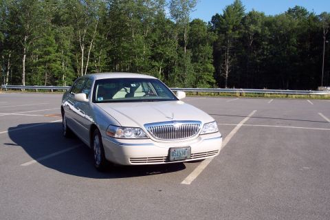 2001 Ford Crown Victoria - This 2004 Lincoln Town Car is parked in a lot with trees in the background. The license plate reads US1534.