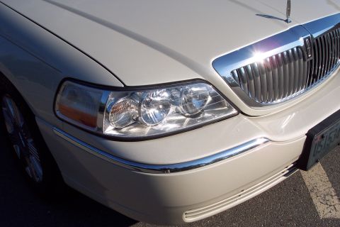 2001 Ford Crown Victoria - Close-up of the front grille and headlights on a Lincoln Town Car.