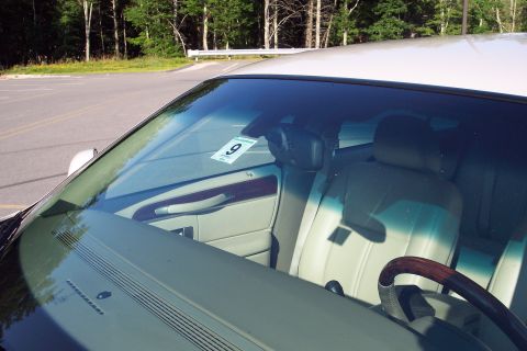 2001 Ford Crown Victoria - Interior view of a car, with a parking tag visible on the windshield.