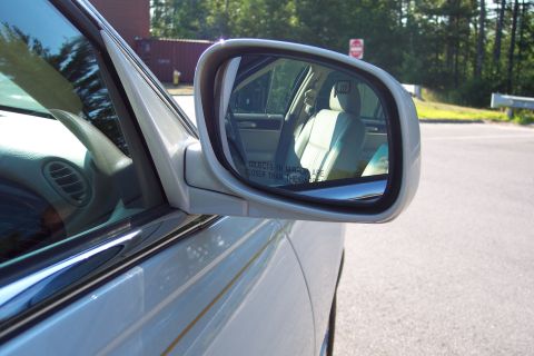 2001 Ford Crown Victoria - Reflection in the side mirror shows the car's interior and seats.