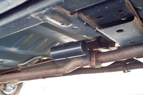 2001 Ford Crown Victoria - The undercarriage of a vehicle, focusing on the exhaust system and frame components.