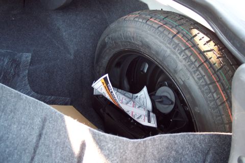 2001 Ford Crown Victoria - Spare tire and warning label are visible in the trunk of the vehicle.