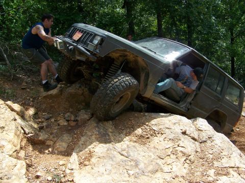 1992 Jeep YJ - Off-roading Jeep Cherokee XJ gets stuck on rocks, requiring assistance.
