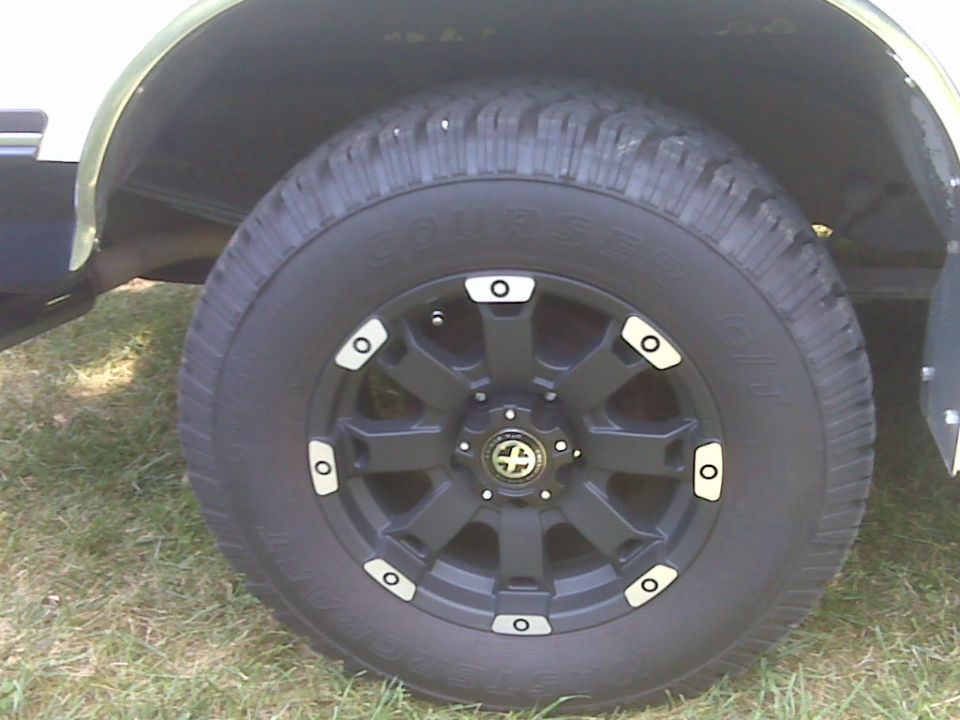 Close-up of Mastercraft Courser C/T tire on black wheel with silver accents in a wheel well