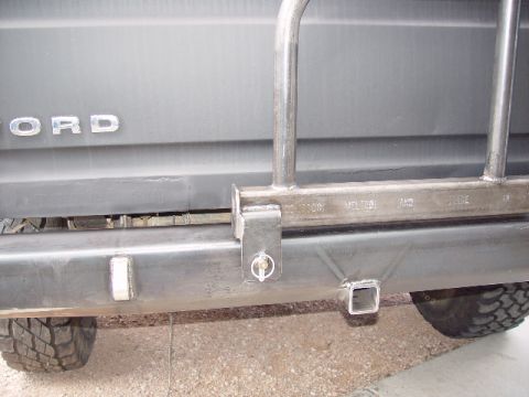 1978 Ford Bronco - The rear of a 1978 Ford Bronco shows a custom bumper with a tow hitch and metal tubing attached.