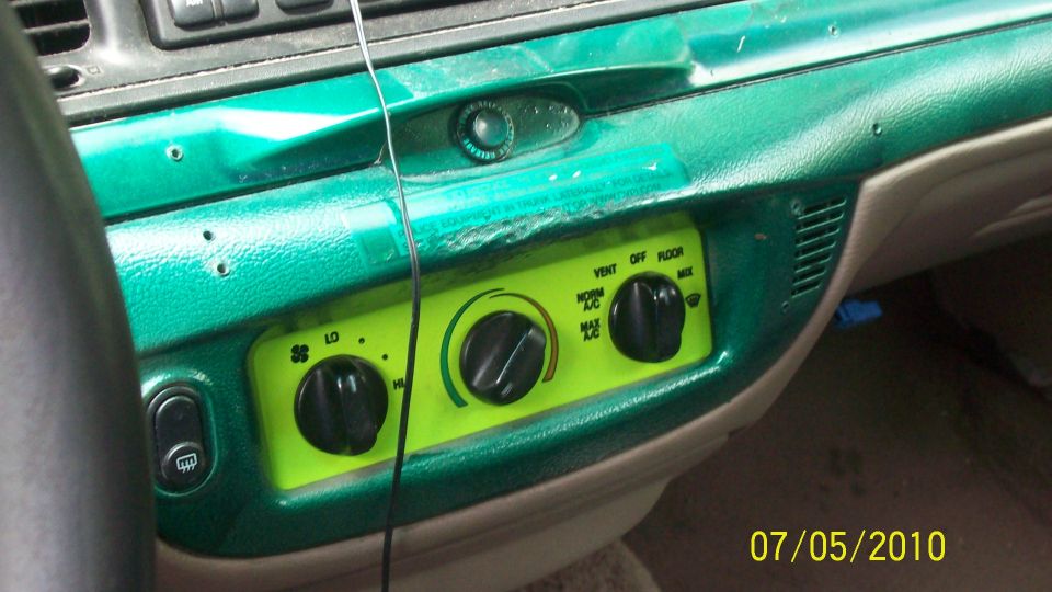 2004 Ford Crown Victoria interior dashboard with green painted trim and climate controls