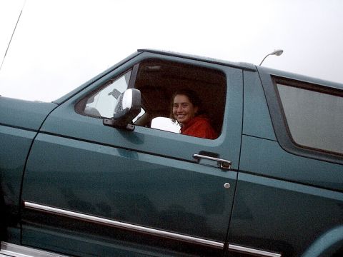 1996 Ford Bronco - Woman driving a 1996 Ford Bronco on an overcast day.