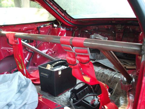 1994 Ford Probe - Car interior modified with a roll cage and racing harnesses, stripped of most components.