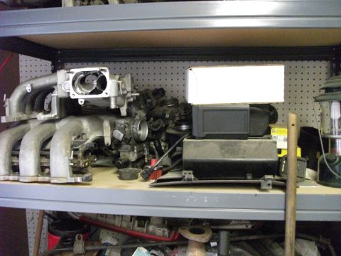 1994 Ford Probe - Engine intake manifold assembly with various components, likely for a car or truck, stored on a shelf.