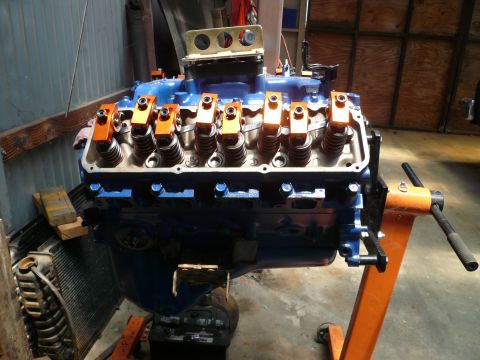 1975 Ford Ranchero - Engine on stand with visible radiator. No specific year or make identifiable from the image.