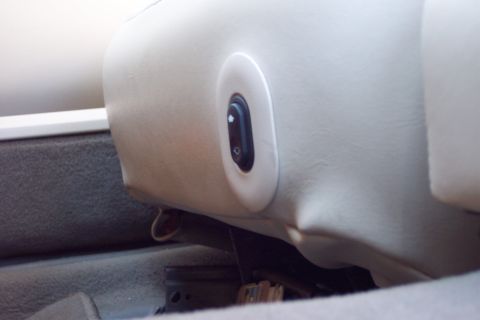 2001 Ford Crown Victoria - Close-up of a car's interior seat control panel, showing buttons for window and lock functions.