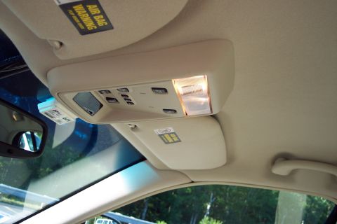 2001 Ford Crown Victoria - Interior view of a car's overhead console and sun visors, showing warning labels.