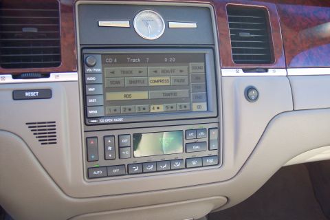 2001 Ford Crown Victoria - Interior view of a Lincoln Town Car's dashboard, the infotainment system and climate controls.