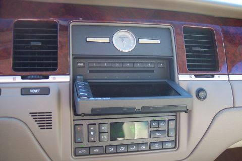 2001 Ford Crown Victoria - The dashboard features a multi-disc CD player and digital climate controls with wood grain accents.