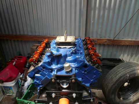 1975 Ford Ranchero - Engine block with orange valve covers and intake manifold, ready for assembly.