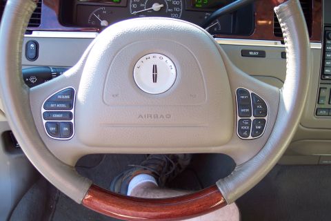 2001 Ford Crown Victoria - Interior view of a Lincoln Town Car, showing the steering wheel, dashboard, and wood accents.