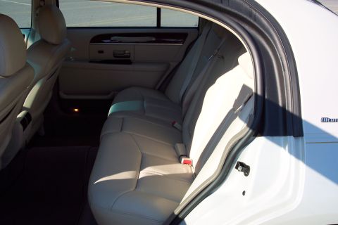 2001 Ford Crown Victoria - The interior of a Lincoln Town Car, showing the rear seating area and door panel.