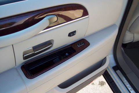 2001 Ford Crown Victoria - Close-up of the interior door panel, wood trim and power controls.