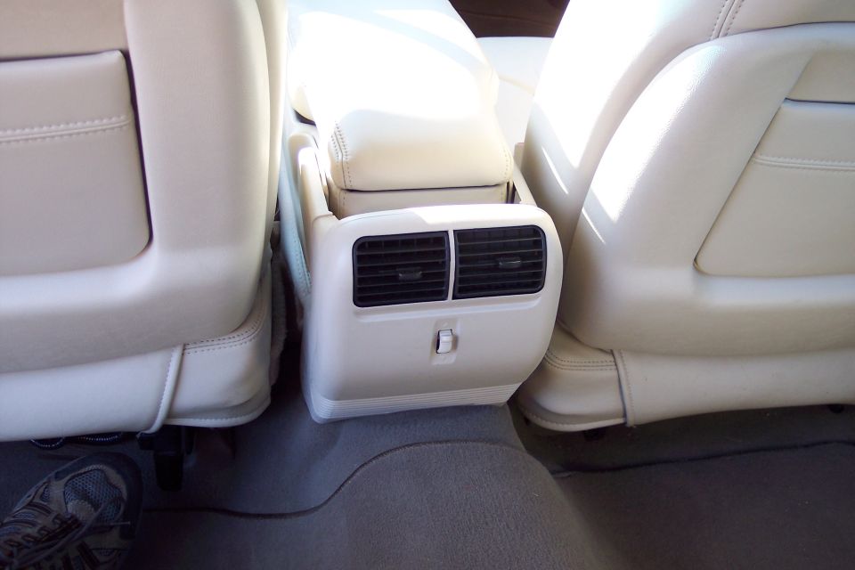 Rear seat air vents and cream leather interior of a car