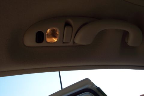 2001 Ford Crown Victoria - Close-up of the interior overhead console, showing the light and grab handle.