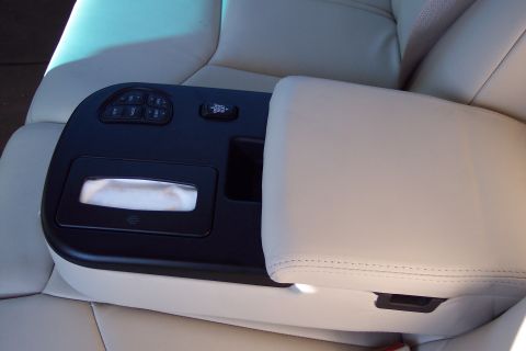 2001 Ford Crown Victoria - The interior of a car shows a center console with climate controls and a tissue dispenser.