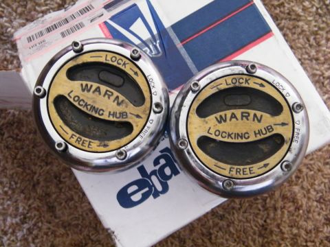 1982 Ford Bronco - Pair of Warn locking hubs, likely for a 4x4 vehicle, shown on a box.