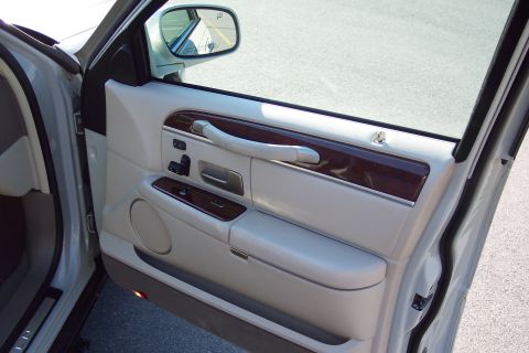 2001 Ford Crown Victoria - Close-up of the interior door panel, wood trim accents and tan leather upholstery.