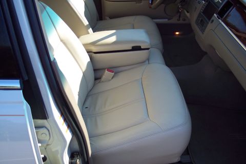 2001 Ford Crown Victoria - Interior view shows light-colored leather seats and the center console.