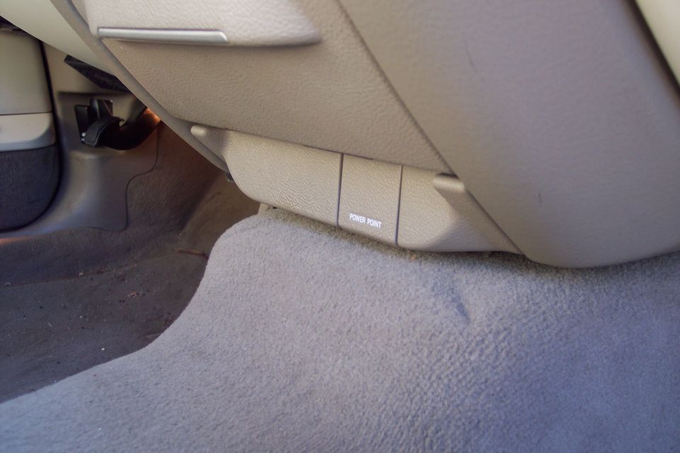 Tan interior car panel with a 'POWER POINT' label visible on a small door