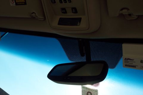 2001 Ford Crown Victoria - View from inside a vehicle shows the rearview mirror, windshield, and overhead console with an EZ-Pass device.