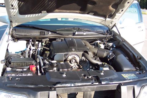 2001 Ford Crown Victoria - Engine bay of a 2001 Ford Crown Victoria, showing the engine, battery, and various components under the hood.