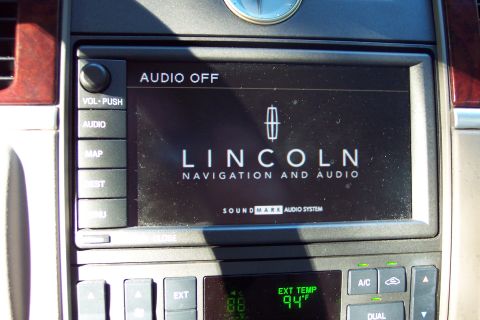 2001 Ford Crown Victoria - The dashboard displays the Lincoln logo and navigation system, with climate controls visible below.