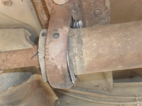 1991 Ford F-350 - Underside view of a driveshaft carrier bearing support bracket, showing rust and wear.