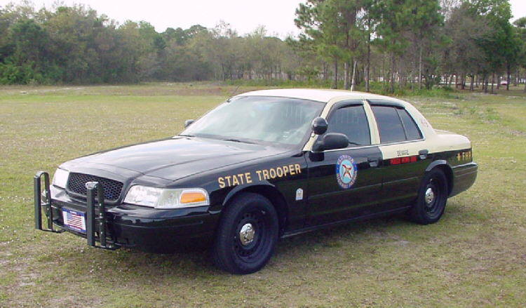 Florida State Trooper Crown Victoria with push bumper parked in a grassy field