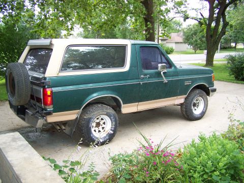 1989 Ford Bronco - Side view of a 1989 Ford Bronco parked on a driveway.