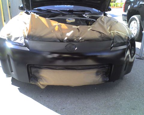 1993 Ford C-350 (Centurion Conversions) - Front view of a Nissan 350Z with its front end masked off for painting. The hood is open.