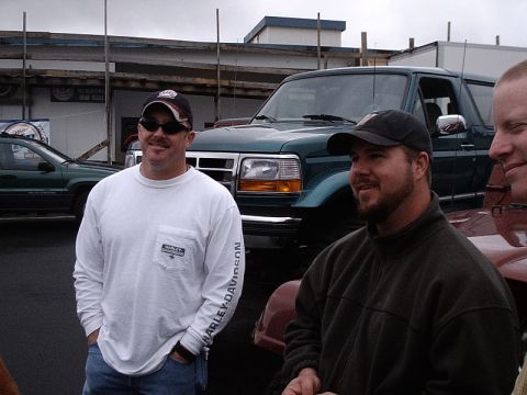 1996 Ford Bronco - A green Ford Bronco is parked outdoors with two men in the foreground.